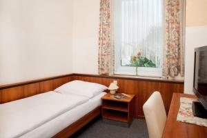 Ένα ή περισσότερα κρεβάτια σε δωμάτιο στο Hubertushof Fromwald Hotel und Gasthof