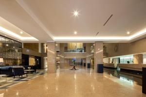 an empty lobby of a building with chairs and tables at Eurostars Gran Hotel Lugo in Lugo