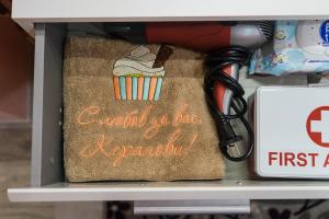 a towel with a cupcake on it on a shelf at Apartment Eve in Varna City
