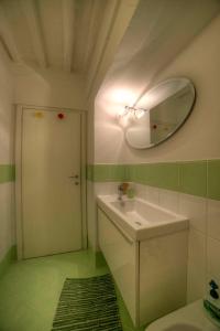 a bathroom with a sink and a mirror on the wall at Cozy Apartment in the heart of Siena in Siena