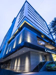 a blue building with a car parked in front of it at Ramee Grand Hotel and Spa, Pune in Pune