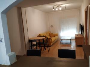 a living room with a couch and a table at Apartamento CUATTRO vut 47-169 wifi in Valladolid
