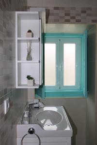 a bathroom with a sink and a blue cabinet at Casinha Verde in Nadadouro