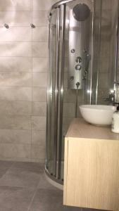 a bathroom with a glass shower and a sink at apartament bermudas in Benidorm