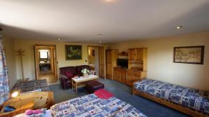 a living room with two beds and a couch at River Side Holiday Home near Besenova in Ivachnová
