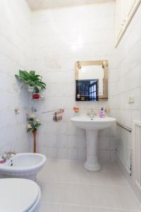 a bathroom with a sink and a toilet and a mirror at Apartment in the center of Kharkiv in Kharkiv