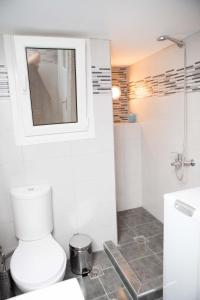 a white bathroom with a toilet and a sink at Acropolis,Historic center Apartment-update in Athens +25 photos