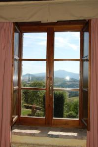 an open window with a view of a mountain at Borgo Fastelli in Sarteano