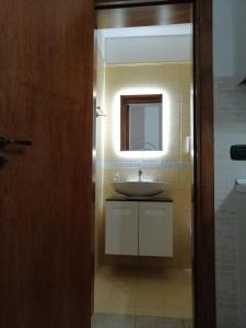 W łazience znajduje się umywalka i lustro. w obiekcie Lu Marchese w mieście Minervino di Lecce