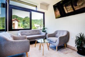 a living room with two chairs and a table at Hotel Odissey Jaz in Budva