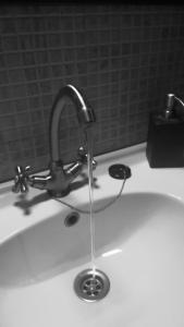 a kitchen sink with a water faucet at Casa rural El Tejo in Bermiego +18 photos