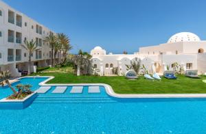 an external view of a villa with a swimming pool at Ulysse Djerba Thalasso & SPA in Houmt Souk