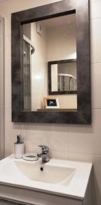 a bathroom with a sink and a mirror at Apartament Bielany Oczapowskiego in Warsaw