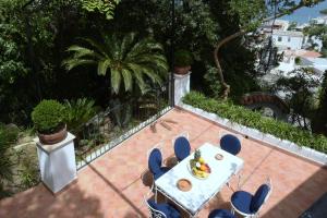 une table et des chaises avec une assiette de nourriture dans l'établissement Aglaia Luxury Seaview Villa, à Ischia