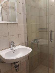 a bathroom with a sink and a shower at Monolithos Villas in Kipri