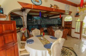 uma sala de jantar com mesa e cadeiras em Rayon Hotel em Negril