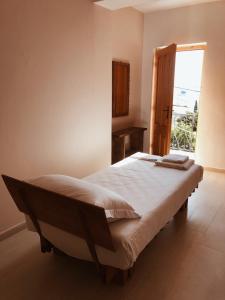 a bedroom with a large bed with a window at Old Town Hotel Dhermi in Dhërmi