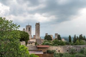 an old castle with two towers on a hill at CASA DEL MEDIOEVO in San Gimignano