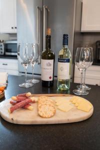 a cutting board with meats and cheese and two bottles of wine at The Germantown Inn in Nashville