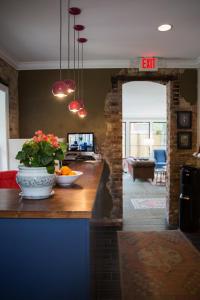 a kitchen with a counter with a vase of flowers at The Germantown Inn in Nashville