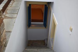 a stairway with a blue window in a building at Monolithos Villas in Kipri