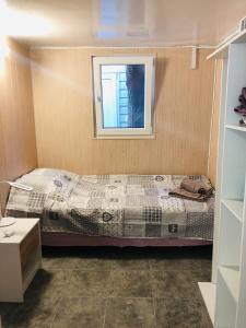 a bedroom with a bed and a window at Дача у моря in Vapnyarka +9 photos