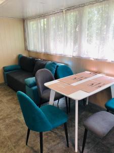 a room with a table and chairs and a couch at Дача у моря in Vapnyarka