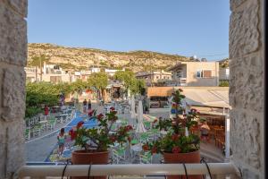 a view from a window of a town with tables and chairs at Ageliki Studio in Matala