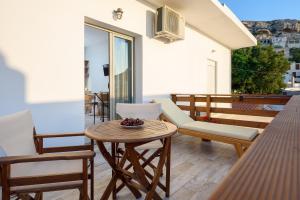 a patio with a table and chairs on a balcony at Ageliki Studio in Matala