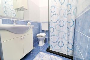 a bathroom with a toilet and a shower curtain at Vila Mila in Vela Luka +36 photos