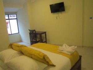 Voodi või voodid majutusasutuse Hostal CañaLimeña toas