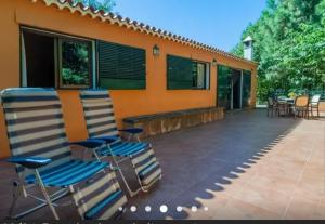 a pair of chairs sitting on a patio at Finca La Casita in La Orotava +8 photos