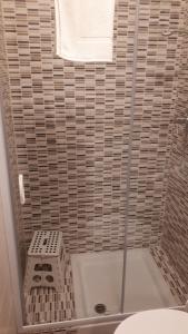 a bathroom with a shower with a toilet and a towel at Le camere di Sabrina con bagno in camera in Sarzana +37 photos