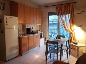 a kitchen with a white refrigerator and a table with chairs at Nanaapartments in Perea