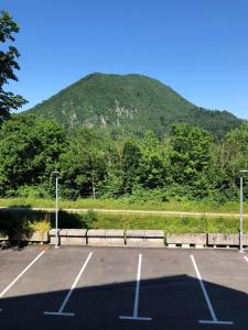 a parking lot with a mountain in the background at B&B Cirman in Ljubljana