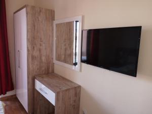a room with a flat screen tv on a wall at Rooms Ibrocevic in Ulcinj