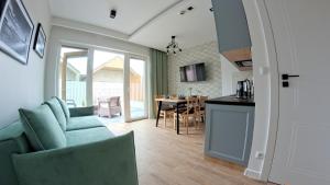 a living room and kitchen with a couch and a table at Baltic Pearl in Ustka