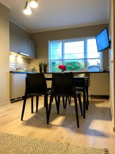 a kitchen with a table and chairs in a room at Medus in Ventspils