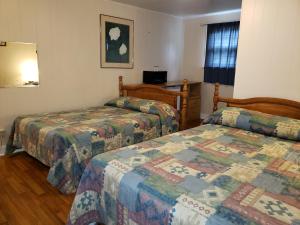Postel nebo postele na pokoji v ubytování Regent Motel