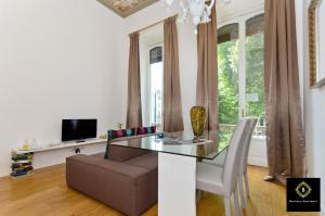 a living room with a table and a couch at Boutique Apartment Elegantissima in Turin