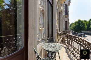 a balcony with a table and benches on a building at Boutique Apartment Elegantissima in Turin
