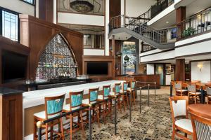 a bar in a restaurant with chairs and tables at The Inn at Saint Mary's in South Bend