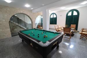 a pool table in a room with a fireplace at Vila Mila in Vela Luka