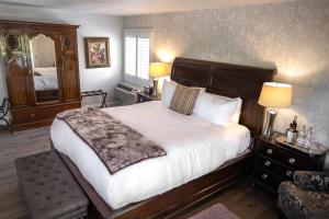 a bedroom with a bed and a dresser at Mirabelle Inn & Restaurant in Solvang
