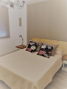 a bed with two pillows on it in a bedroom at Japan Beach Parque del Oeste in Málaga