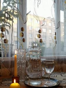 un tavolo con un barattolo di vetro, una candela e un candeliere di DvīņuMājas Vintage B&B a Balvi