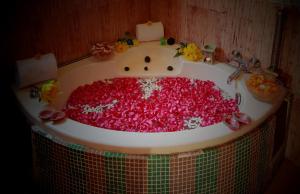 a sink filled with lots of red sprinkles at Regenta Orko's Haridwar, Motichur in Haridwār