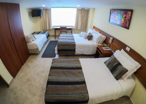 Postel nebo postele na pokoji v ubytování Hotel Estación Sabana