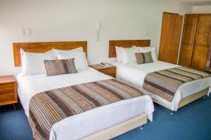 Postel nebo postele na pokoji v ubytování Hotel Estación Sabana