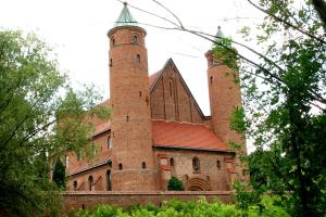 a building with two towers on top of it at Strefa Kampinos in Brochów